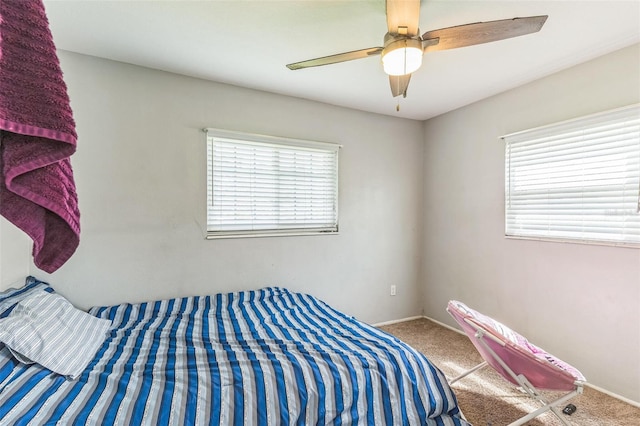 bedroom with carpet floors, baseboards, and a ceiling fan