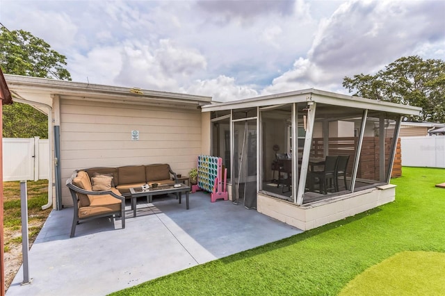 back of property with a sunroom, a patio, and outdoor lounge area