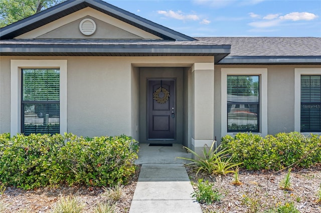 337 Southern Winds Blvd, Deland, FL 32720 - entrance to property featuring stucco siding and a shingled roof