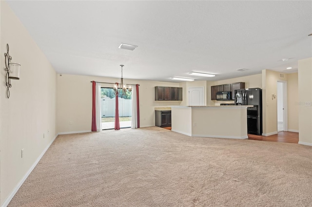 337 Southern Winds Blvd, Deland, FL 32720 - unfurnished living room with light carpet, a chandelier, and baseboards