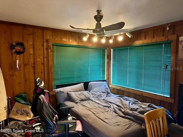 505 Lakeview Ave, Titusville, FL 32796 - bedroom with wooden walls and a ceiling fan