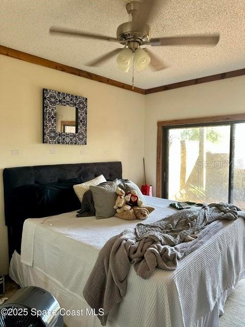 505 Lakeview Ave, Titusville, FL 32796 - bedroom with a textured ceiling and ceiling fan