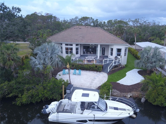 back of property featuring a tile roof