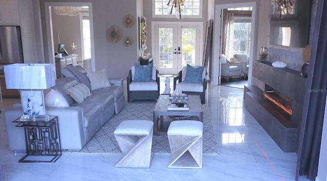 living area featuring marble look tile flooring and french doors