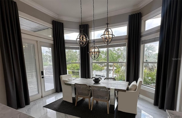 dining area featuring a chandelier, light marble finish floors, and crown molding
