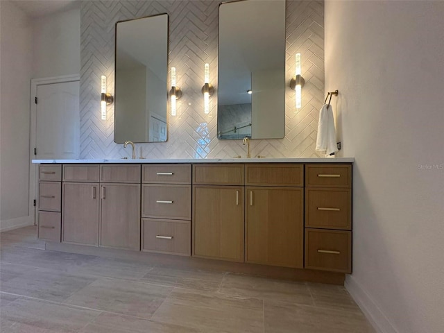 full bathroom featuring decorative backsplash, baseboards, and double vanity