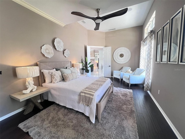 bedroom with baseboards, wood finished floors, and a ceiling fan