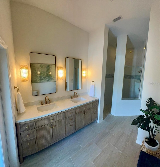 bathroom with walk in shower and double vanity