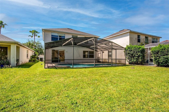 5007 Bellthorn Dr, Orlando, FL 32837 - back of house with a lawn, an outdoor pool, glass enclosure, and stucco siding