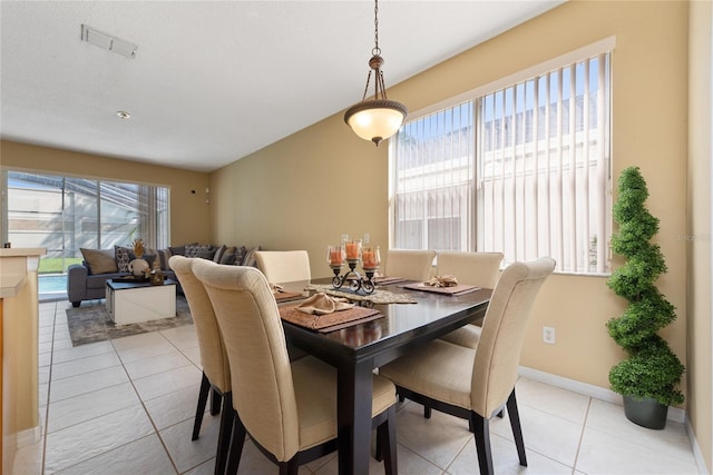 5007 Bellthorn Dr, Orlando, FL 32837 - dining space with light tile patterned floors and baseboards