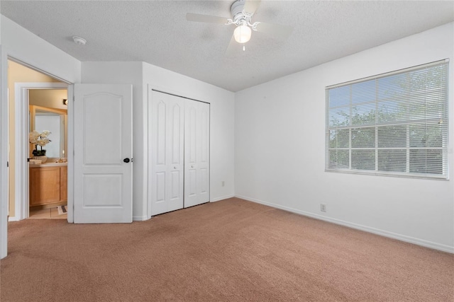 5007 Bellthorn Dr, Orlando, FL 32837 - unfurnished bedroom featuring carpet flooring, a textured ceiling, a closet, baseboards, and a ceiling fan