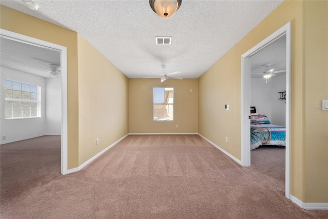 5007 Bellthorn Dr, Orlando, FL 32837 - unfurnished room featuring a ceiling fan, carpet flooring, a textured ceiling, and healthy amount of natural light