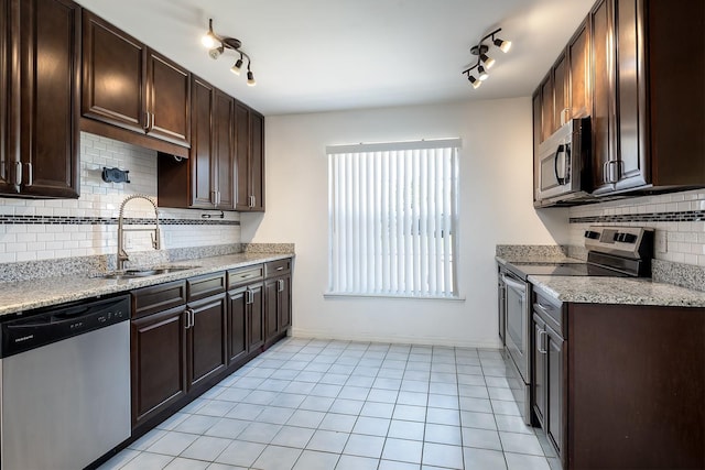 18 Palmira Rd, Debary, FL 32713 - kitchen with stainless steel appliances, a sink, track lighting, and dark brown cabinetry