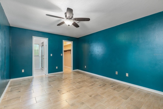 18 Palmira Rd, Debary, FL 32713 - unfurnished bedroom with a walk in closet, a textured ceiling, wood finish floors, ceiling fan, and baseboards