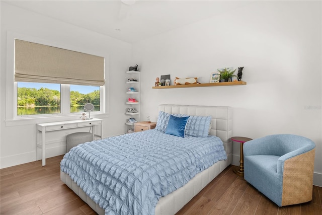 bedroom with wood finished floors and baseboards