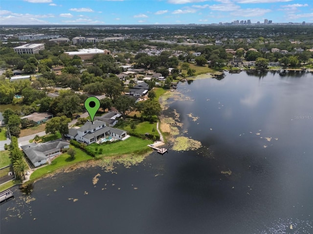 aerial view of property and surrounding area featuring a nearby body of water and nearby urban area