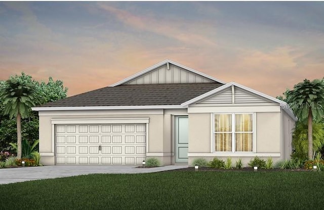 view of front of home featuring an attached garage, concrete driveway, a lawn, roof with shingles, and stucco siding