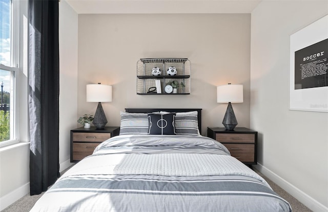 carpeted bedroom with baseboards