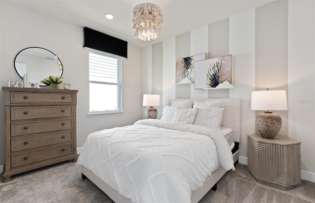 bedroom featuring light carpet, a chandelier, and baseboards