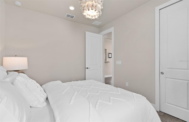 bedroom featuring a chandelier and baseboards