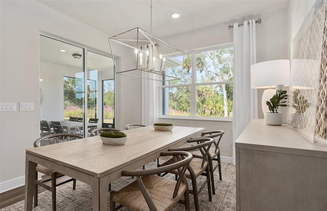 dining area with baseboards, a chandelier, wood finished floors, and recessed lighting