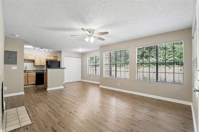 485 Forestway Cir Unit 108, Altamonte Springs, FL 32701 - unfurnished living room with a ceiling fan, wood finished floors, track lighting, baseboards, and a textured ceiling