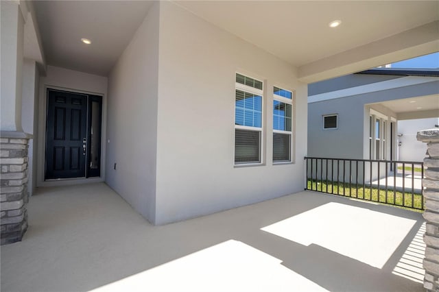 doorway to property with stucco siding