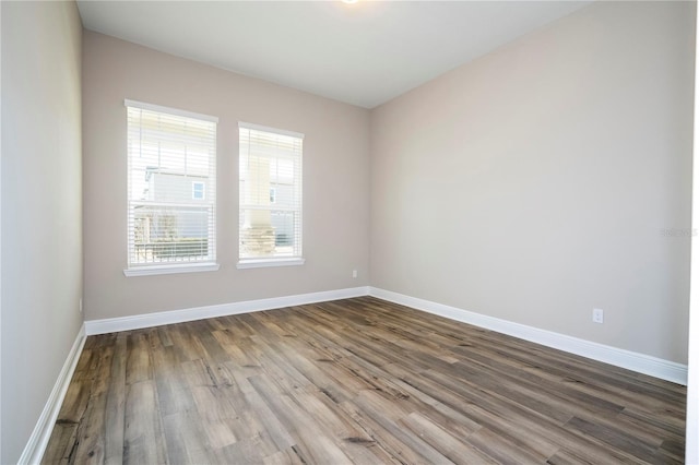 empty room with wood finished floors and baseboards