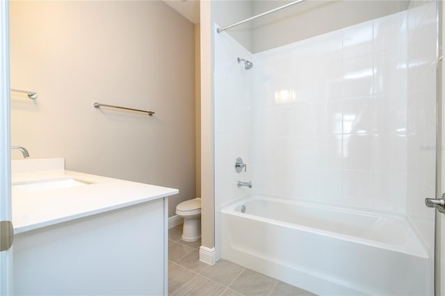 bathroom featuring toilet, tile patterned flooring, bathtub / shower combination, vanity, and baseboards