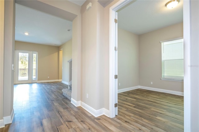 hallway with wood finished floors and baseboards