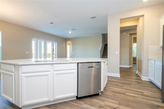kitchen with dishwasher, light wood-style flooring, white cabinets, baseboards, and recessed lighting