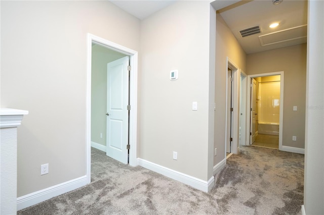 corridor with carpet floors and baseboards