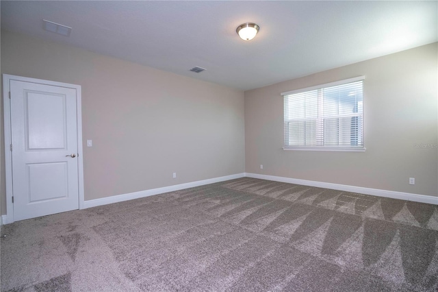 unfurnished room featuring carpet flooring and baseboards
