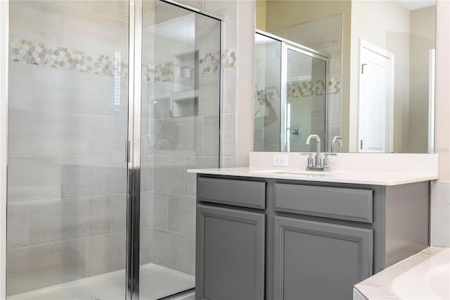 full bathroom featuring a stall shower and vanity