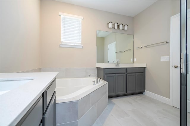 full bathroom featuring two vanities and a bath