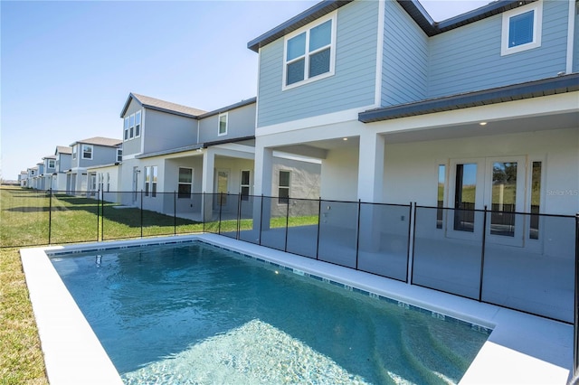 view of pool with french doors and a patio