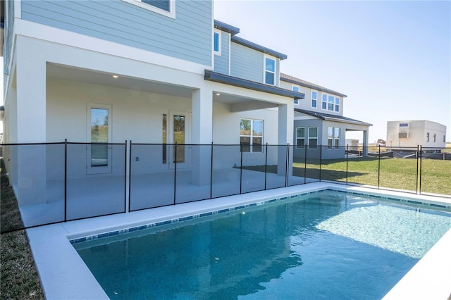 view of swimming pool featuring a patio area and fence