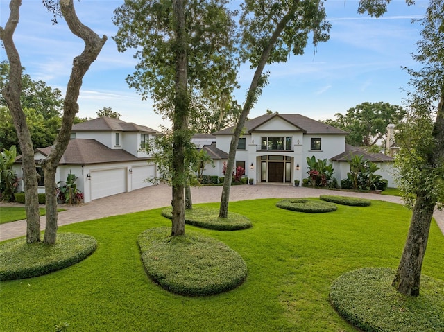 1455 Kelso Blvd, Windermere, FL 34786 - view of front of property with a balcony, decorative driveway, stucco siding, and a front yard