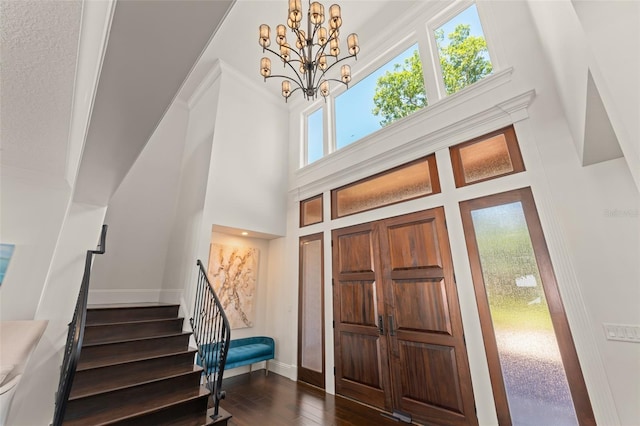 1455 Kelso Blvd, Windermere, FL 34786 - foyer featuring stairway, dark wood-type flooring, a chandelier, baseboards, and a towering ceiling