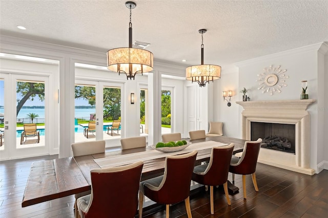 1455 Kelso Blvd, Windermere, FL 34786 - dining area featuring a chandelier, crown molding, dark wood finished floors, a textured ceiling, and french doors