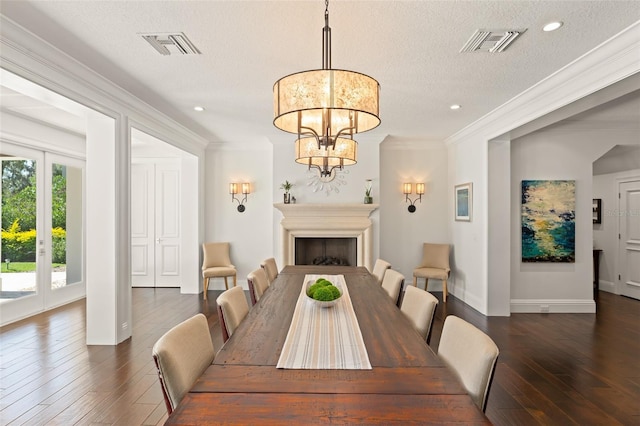 1455 Kelso Blvd, Windermere, FL 34786 - dining room featuring dark wood-type flooring, a textured ceiling, ornamental molding, baseboards, and a chandelier