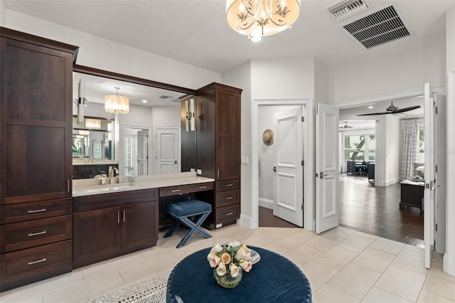 1455 Kelso Blvd, Windermere, FL 34786 - bathroom with a chandelier, vanity, tile patterned flooring, and baseboards
