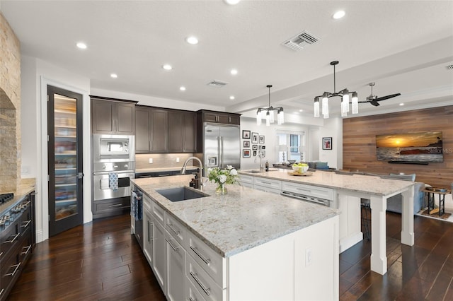 1455 Kelso Blvd, Windermere, FL 34786 - kitchen with built in appliances, a sink, a large island with sink, recessed lighting, and dark wood finished floors