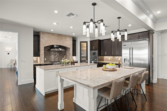 1455 Kelso Blvd, Windermere, FL 34786 - kitchen with a large island with sink, built in appliances, backsplash, recessed lighting, and baseboards