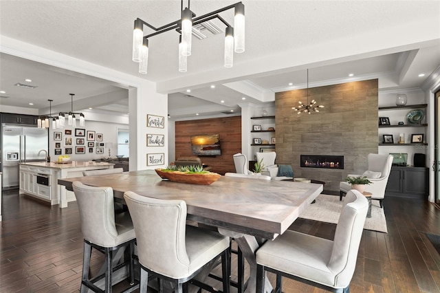 1455 Kelso Blvd, Windermere, FL 34786 - dining area featuring ornamental molding, dark wood finished floors, a chandelier, recessed lighting, and a fireplace
