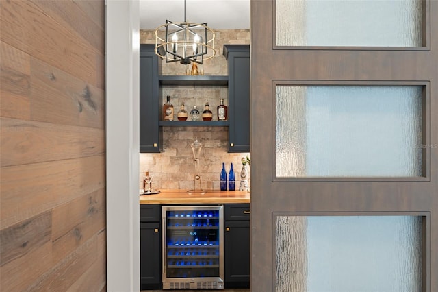 1455 Kelso Blvd, Windermere, FL 34786 - indoor bar featuring beverage cooler, a chandelier, tasteful backsplash, and decorative light fixtures