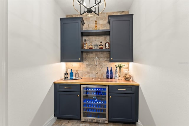 1455 Kelso Blvd, Windermere, FL 34786 - indoor bar featuring beverage cooler, backsplash, baseboards, and a chandelier
