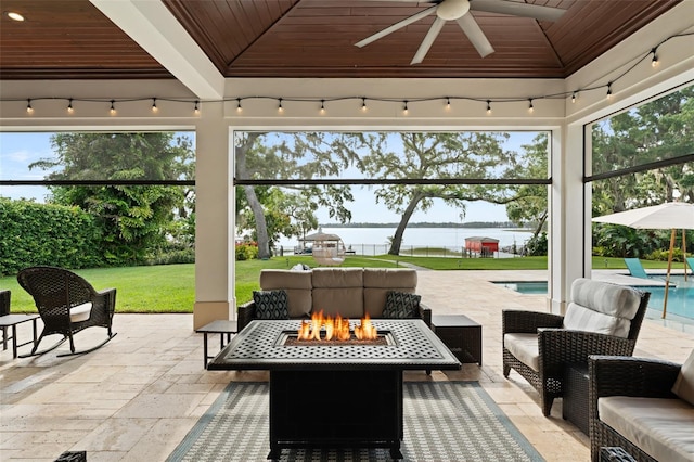 1455 Kelso Blvd, Windermere, FL 34786 - view of patio featuring a water view, a ceiling fan, an outdoor living space with a fire pit, and an outdoor pool