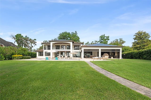 1455 Kelso Blvd, Windermere, FL 34786 - rear view of house featuring a patio, a yard, and a balcony