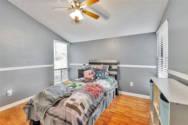 701 Saint Michael Ln, Altamonte Springs, FL 32714 - bedroom with a textured ceiling, wood finished floors, lofted ceiling, a ceiling fan, and baseboards